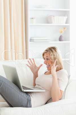 Portrait of an amazed woman using her laptop