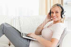Woman with a laptop and headhones