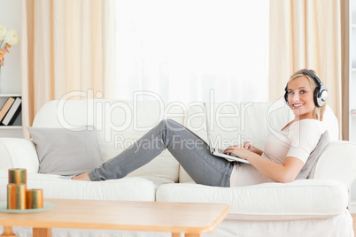 Cute woman with a laptop and headhones