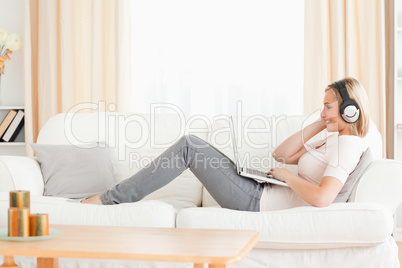 Smling woman watching a movie with her laptop