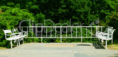 white benches on the green background