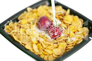 bowl of cornflakes milk  cherry  and strawberry  isolated on whi
