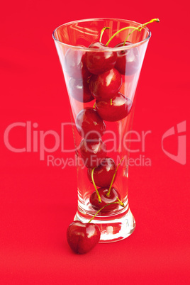 glass of cherry  on a red background