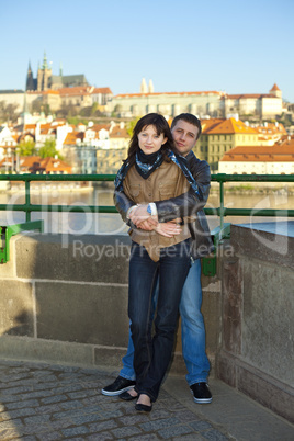 young couple on the Charles Bridge on the skyline