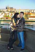 young couple on the Charles Bridge on the skyline