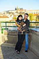 young couple on the Charles Bridge on the skyline