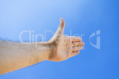 Hand against the blue sky