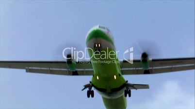 green white turbo prop plane fly over
