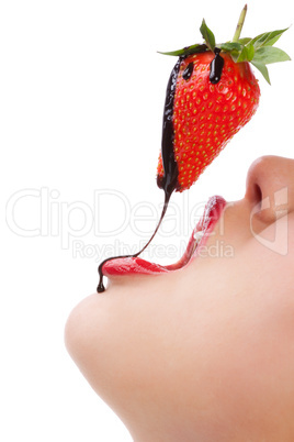 girl eating strawberry with chocolate sauc