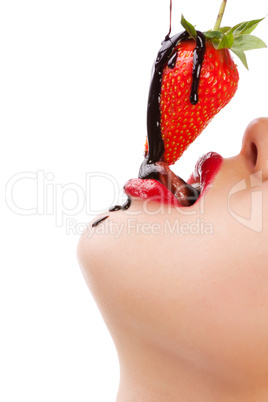 girl eating strawberry with chocolate sauc