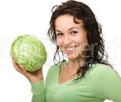 Beautiful young girl with green cabbage