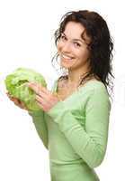 Beautiful young girl with green cabbage