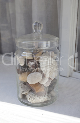 Bank of stones and shells on the windowsill