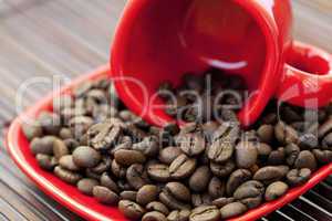 cup and saucer and coffee beans on a bamboo mat