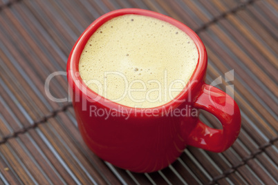 cup of cappuccino on a bamboo mat