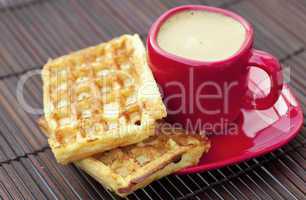 cup of cappuccino wafers on a bamboo mat