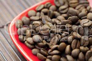 saucer and coffee beans on a bamboo mat
