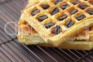 waffles and coffee beans on a bamboo mat