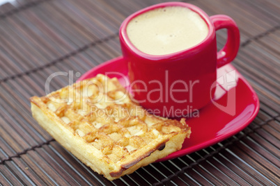 cup of cappuccino wafers on a bamboo mat