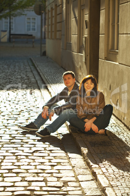 love couple sitting on the pavement