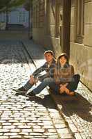 love couple sitting on the pavement
