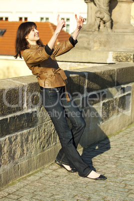 beautiful young woman standing on the bridge