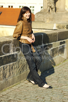 beautiful young woman standing on the bridge