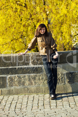 beautiful young woman standing on the bridge