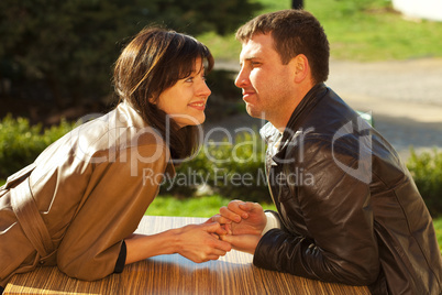 love couple sitting at a table in a cafe