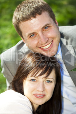 just married in a flowering garden sitting on the grass