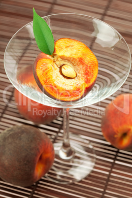 peach in the martini glass on a bamboo mat