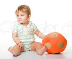 Cute little child is playing with soccer ball