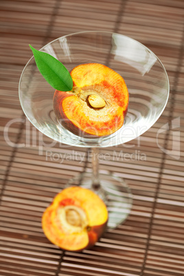 peach in the martini glass on a bamboo mat