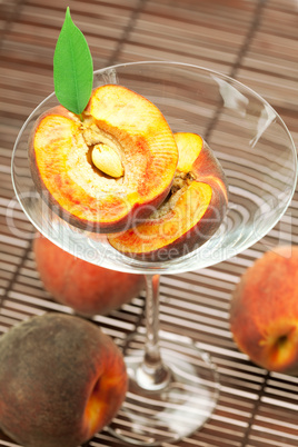 peach in the martini glass on a bamboo mat