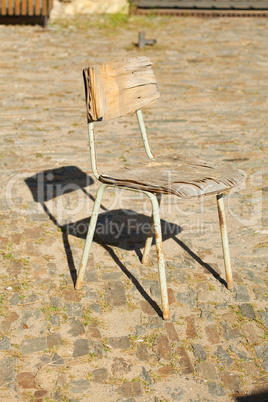 old chair standing on the pavement