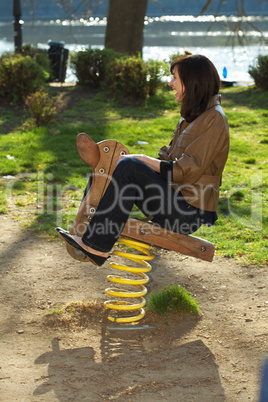 young woman in a baby swing