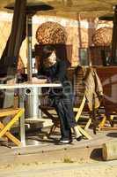 young woman sitting at a table in a cafe