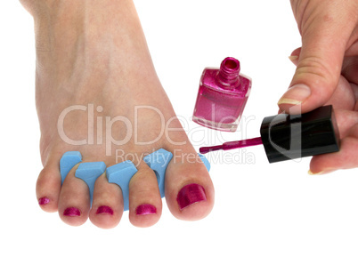 Woman applying pink nail polish isolated on white background.
