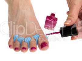 Woman applying pink nail polish isolated on white background.