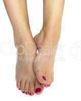 Woman foot with pink nail polish on white