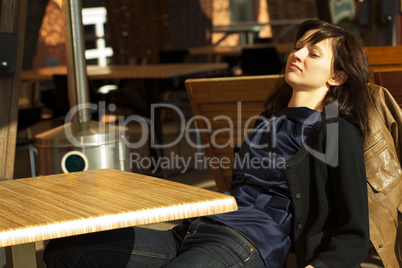 young woman sitting at a table in a cafe