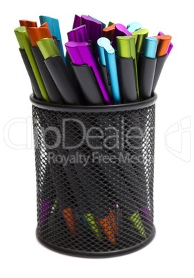 ballpoint pens in pencil holders on white