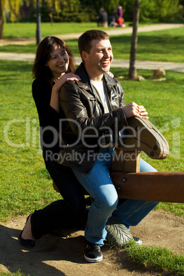 young couple in a baby swing