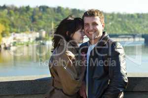 young couple on a bridge on the river