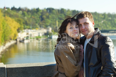 young couple on a bridge on the river young couple on a bridge on the river