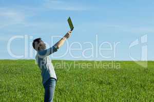 young man using laptop in the field