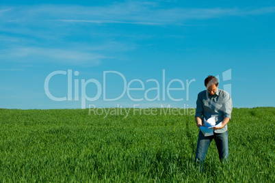 young man throwing a paper in the green field