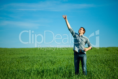 young man throwing a paper in the green field young man throwing a paper in the green field