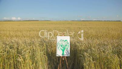 Child's drawing of green tree by chalk in wheat field