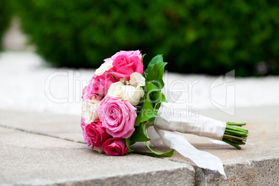 bridal bouquet lying on the stone parapet